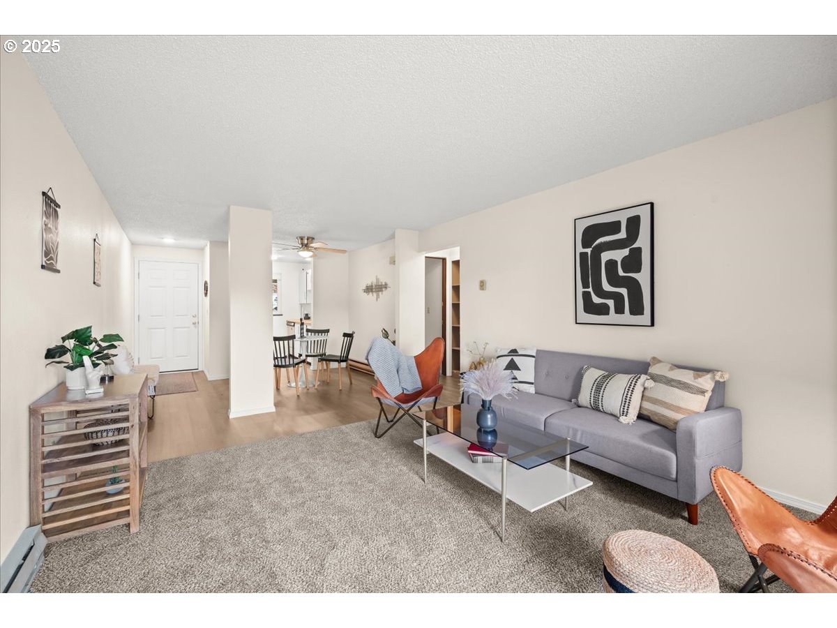 12612 Northwest Barnes Road, Unit 6 Portland, OR 97229 - Photo 13 of 40 a living room with furniture and wooden floor