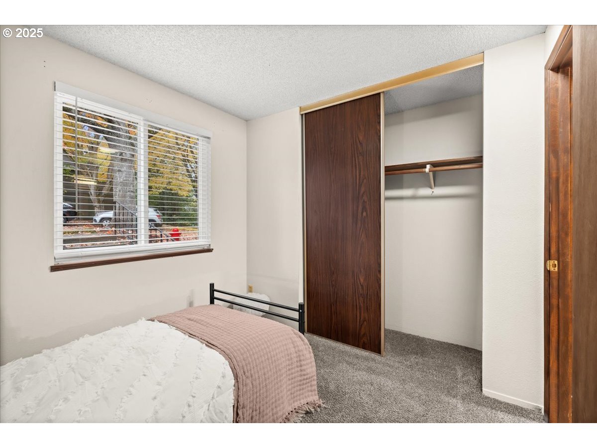 12612 Northwest Barnes Road, Unit 6 Portland, OR 97229 - Photo 14 of 40 a bedroom with a bed and a window