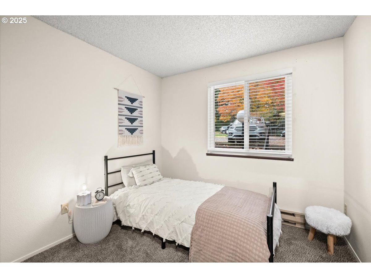 12612 Northwest Barnes Road, Unit 6 Portland, OR 97229 - Photo 15 of 40 a bedroom with a bed and window