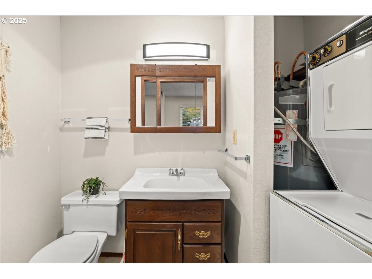 12612 Northwest Barnes Road, Unit 6 Portland, OR 97229 - Photo 16 of 40 a bathroom with a sink and a mirror