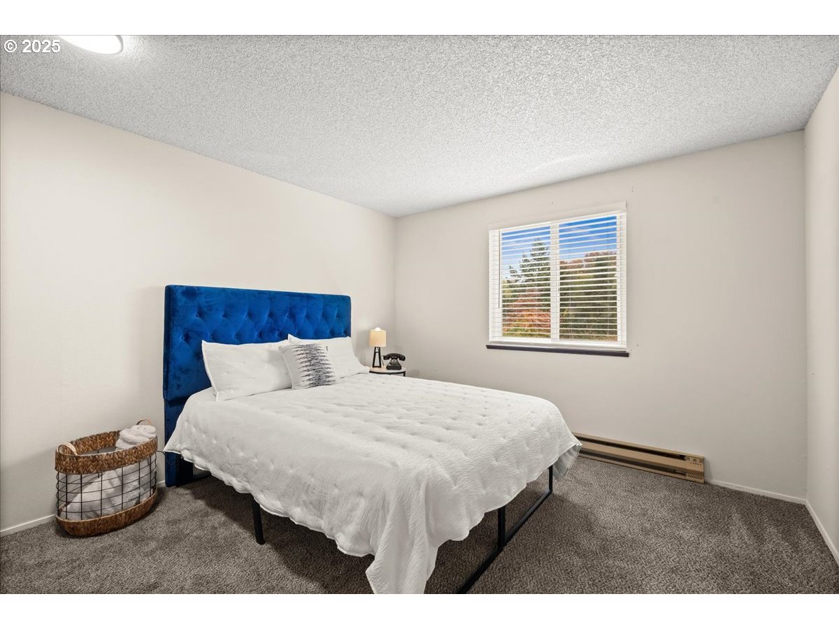 12612 Northwest Barnes Road, Unit 6 Portland, OR 97229 - Photo 18 of 40 a bedroom with a bed and a window