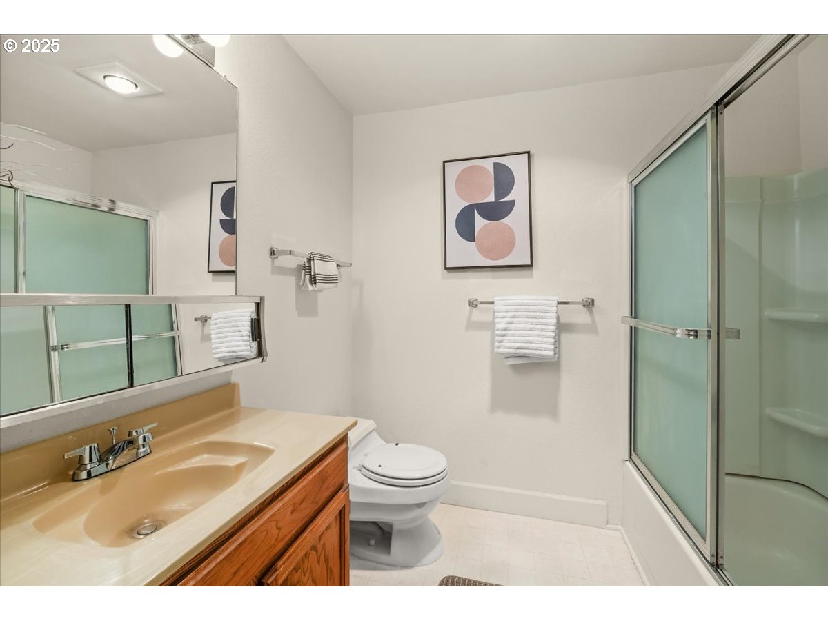 12612 Northwest Barnes Road, Unit 6 Portland, OR 97229 - Photo 21 of 40 a bathroom with a sink a toilet and shower
