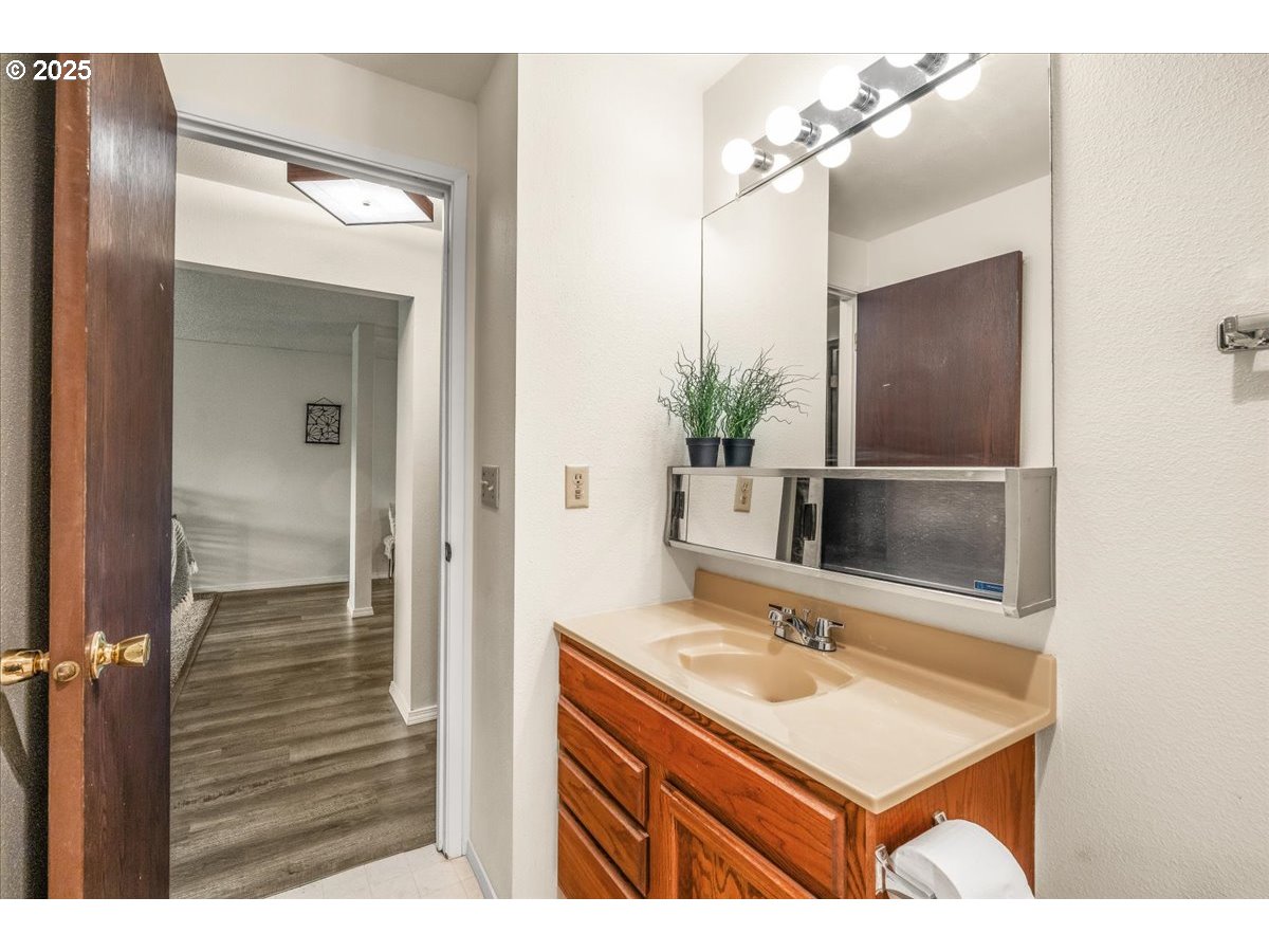 12612 Northwest Barnes Road, Unit 6 Portland, OR 97229 - Photo 22 of 40 a bathroom with a sink and a mirror