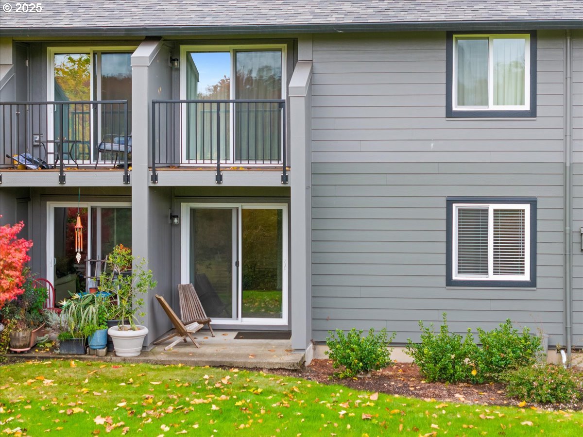 12612 Northwest Barnes Road, Unit 6 Portland, OR 97229 - Photo 24 of 40 a front view of a house with a yard outdoor seating and garage