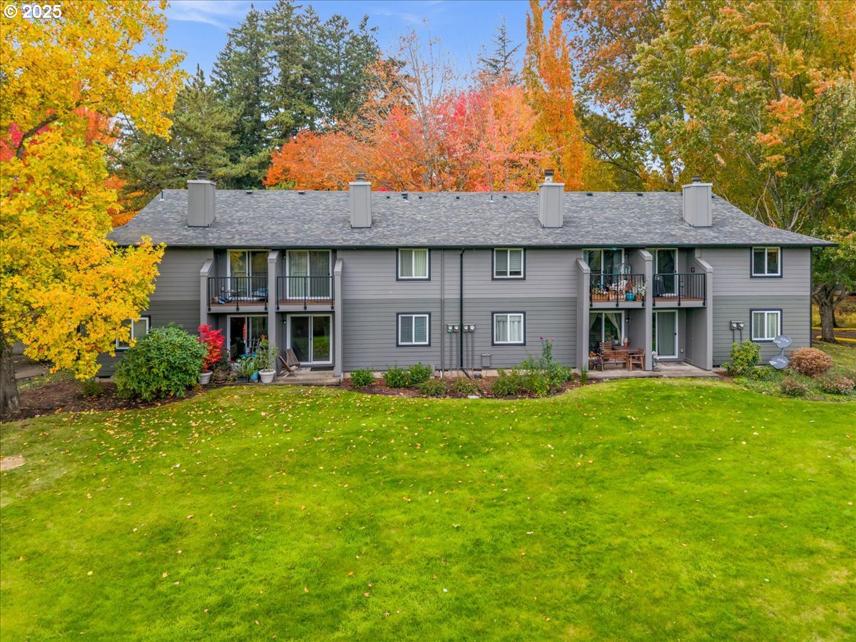 12612 Northwest Barnes Road, Unit 6 Portland, OR 97229 - Photo 25 of 40 a front view of a house with a garden