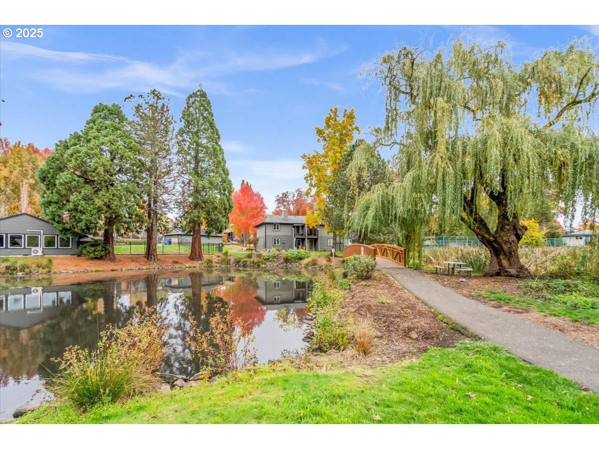 12612 Northwest Barnes Road, Unit 6 Portland, OR 97229 - Photo 31 of 40 a view of a yard with swimming pool and trees