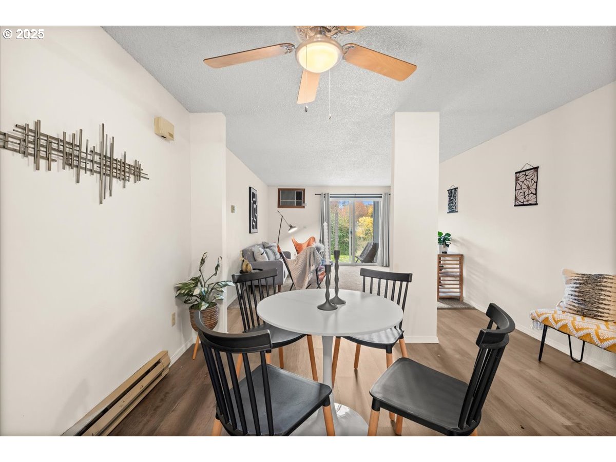 12612 Northwest Barnes Road, Unit 6 Portland, OR 97229 - Photo 10 of 40 a view of a dining room with furniture and wooden floor
