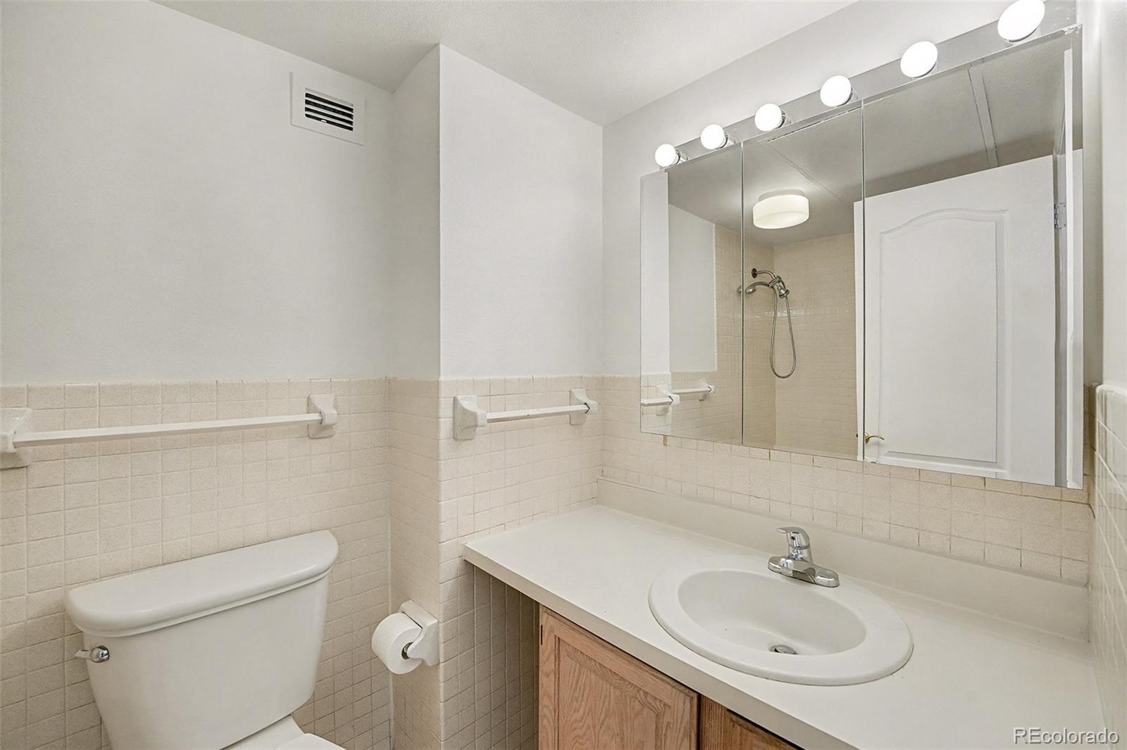 1020 15th Street, Unit 35L Denver, CO 80202 - Photo 11 of 39 a bathroom with a sink toilet and shower