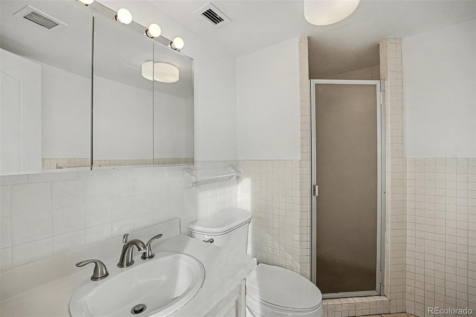 1020 15th Street, Unit 35L Denver, CO 80202 - Photo 13 of 39 a bathroom with a sink a toilet and shower