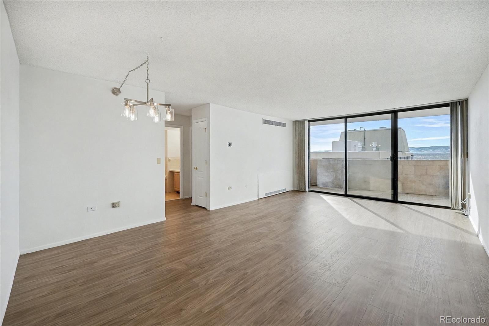 1020 15th Street, Unit 35L Denver, CO 80202 - Photo 2 of 39 an empty room with wooden floor and windows