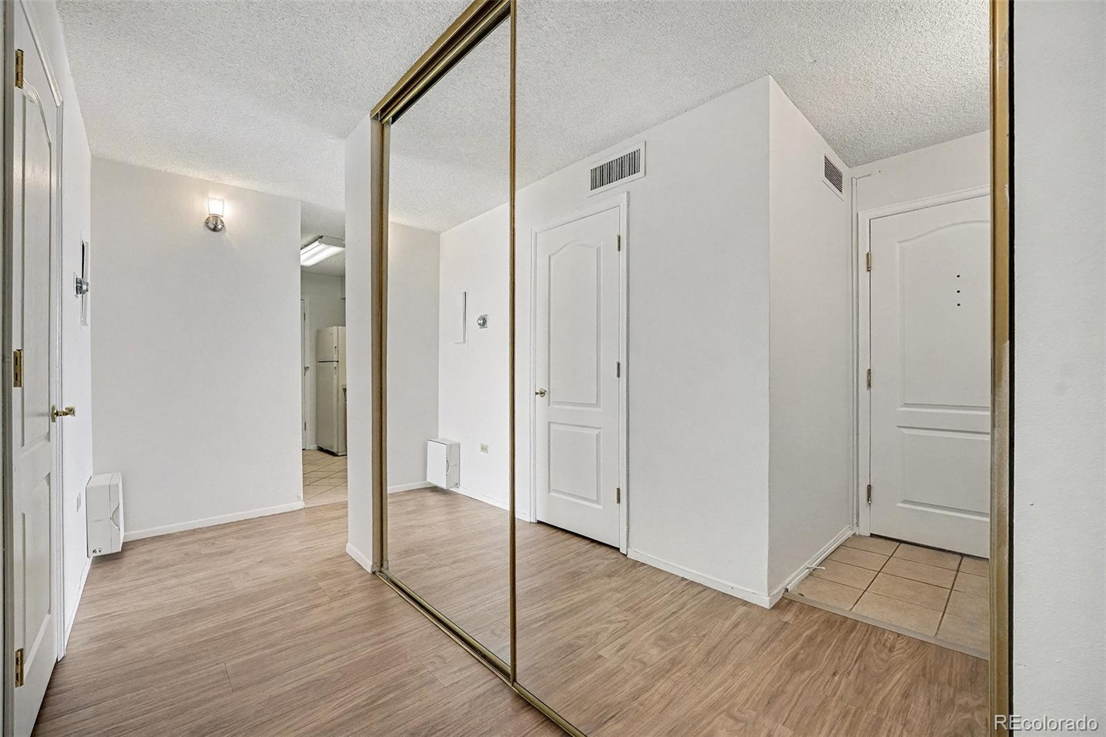 1020 15th Street, Unit 35L Denver, CO 80202 - Photo 5 of 39 a view of an empty room with wooden floor