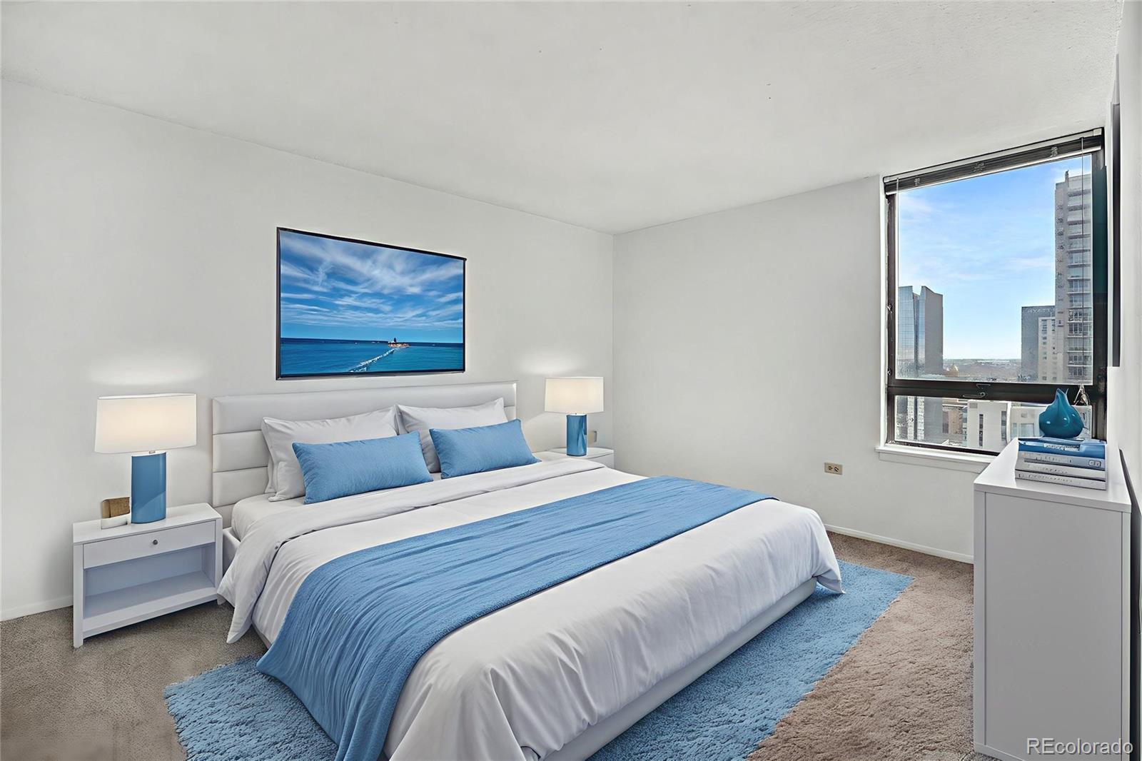 1020 15th Street, Unit 35L Denver, CO 80202 - Photo 9 of 39 a bedroom with a bed a lamp and a large window