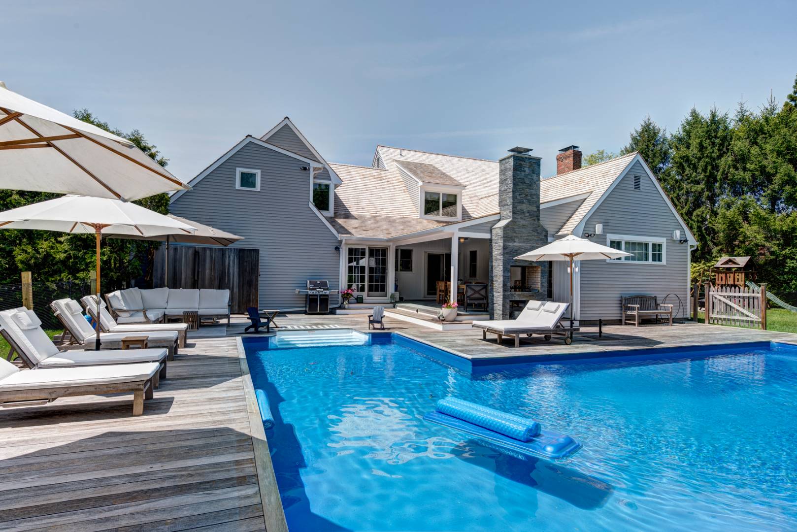 14 Aelfie's Way Bridgehampton, NY 11932 - Photo 1 of 13 a view of house with swimming pool outdoor seating and house in the background