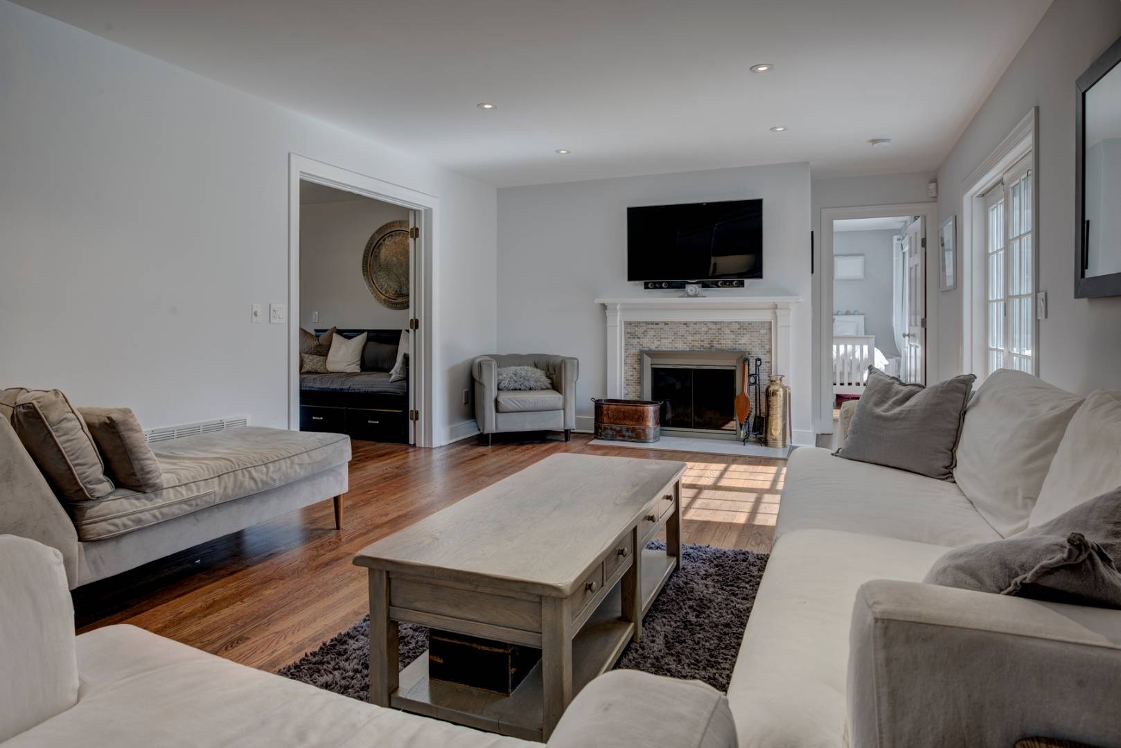 14 Aelfie's Way Bridgehampton, NY 11932 - Photo 5 of 13 a living room with furniture a fireplace and a flat screen tv