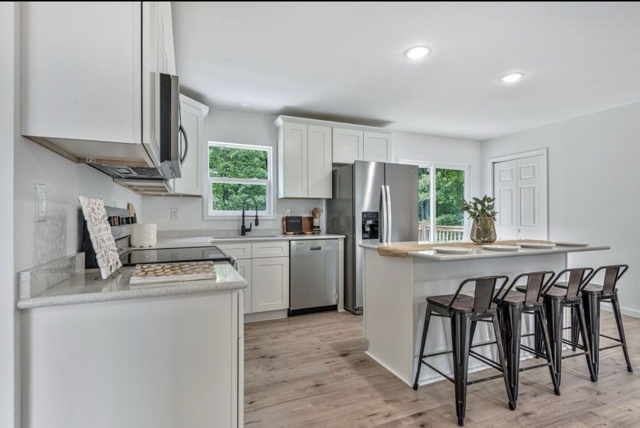 10498 Missionary Ridge Road Bon Aqua, TN 37025 - Photo 15 of 41 a kitchen with a stove a sink cabinets and a refrigerator