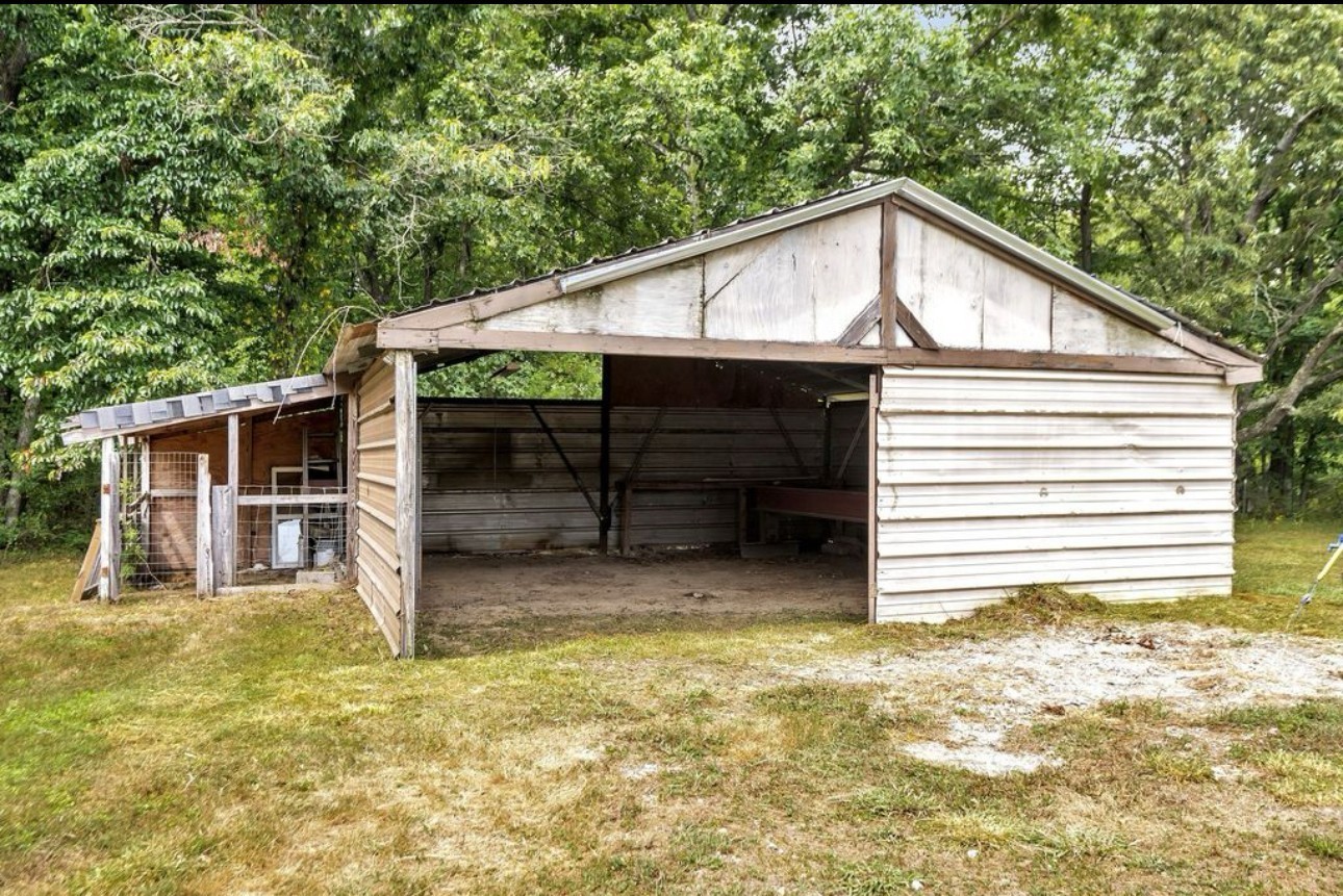 10498 Missionary Ridge Road Bon Aqua, TN 37025 - Photo 40 of 41 a view of house with backyard and garage