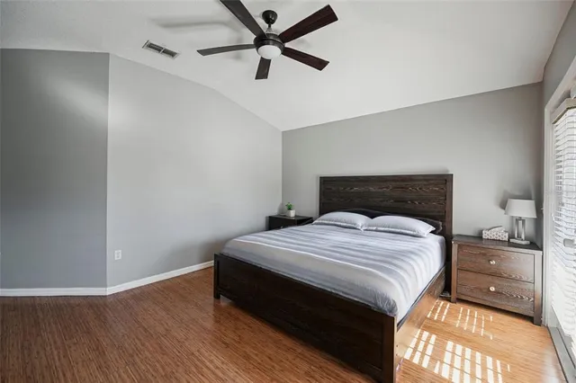 a bedroom with a bed and a night stand