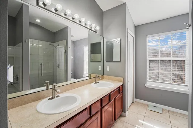 a bathroom with a sink double vanity and a mirror