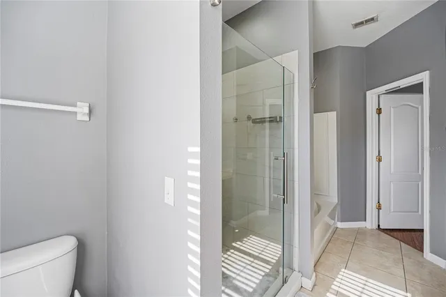 a bathroom with a toilet and shower