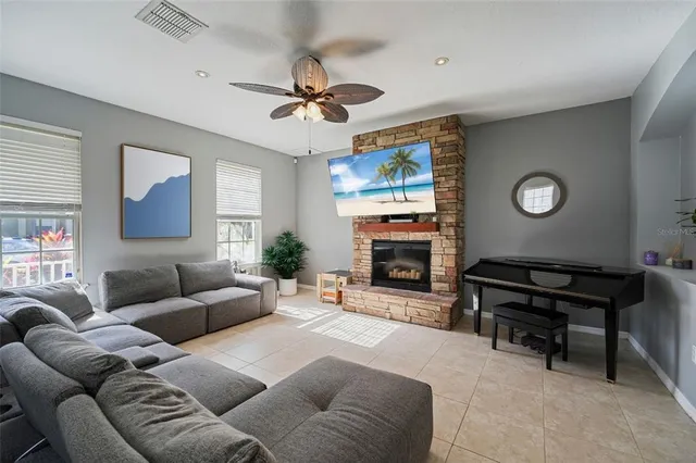 a living room with furniture a fireplace and a flat screen tv