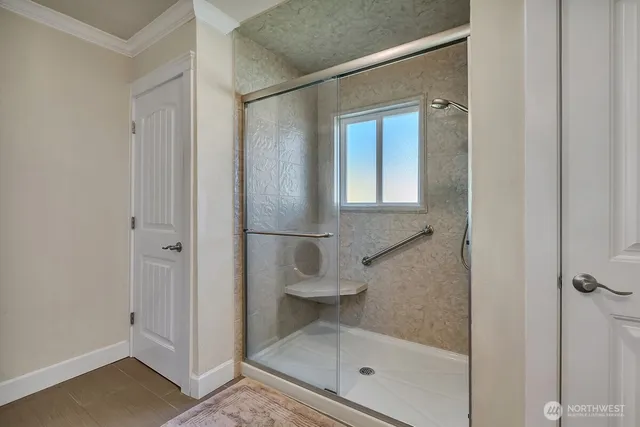 a bathroom with a glass shower door