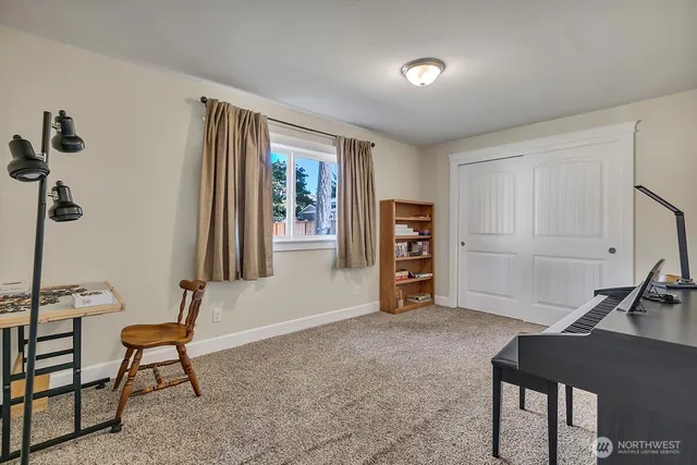 a view of a livingroom with furniture and a window