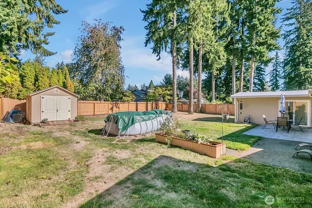 a view of backyard with swimming pool and outdoor seating