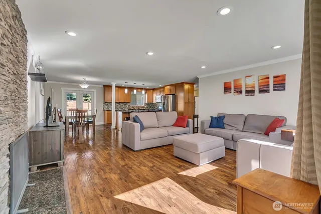 a living room with furniture and a wooden floor