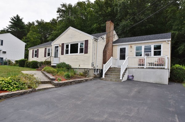 25 Grace Road Woburn, MA 01801 - Photo 12 of 14 a front view of a house with a yard and potted plants