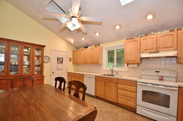 25 Grace Road Woburn, MA 01801 - Photo 2 of 14 a kitchen with granite countertop a stove a sink and a microwave