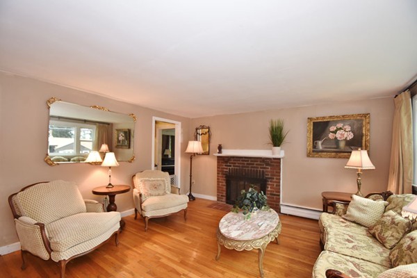 25 Grace Road Woburn, MA 01801 - Photo 4 of 14 a living room with furniture a fireplace and a table