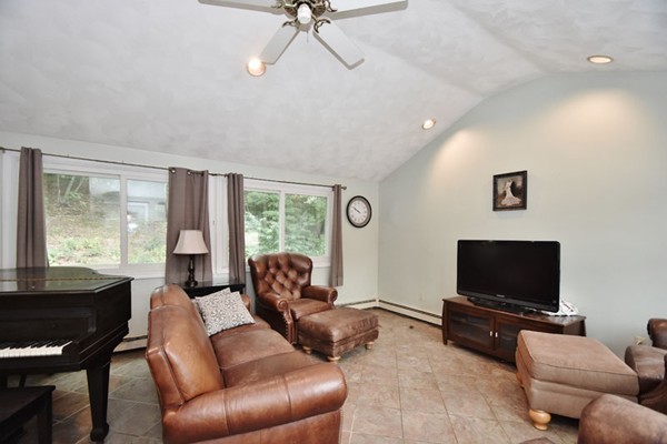 25 Grace Road Woburn, MA 01801 - Photo 6 of 14 a living room with furniture and a flat screen tv