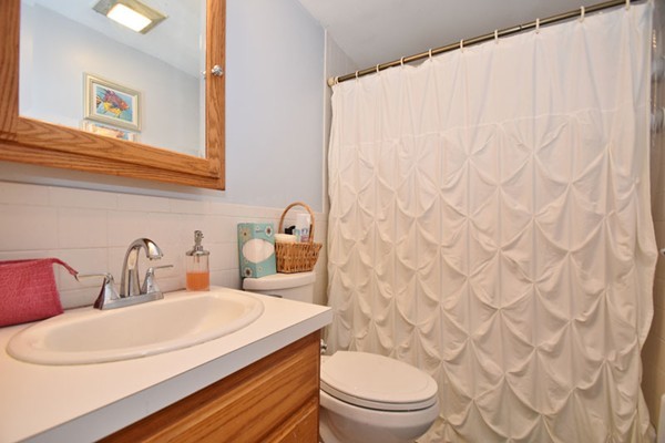 25 Grace Road Woburn, MA 01801 - Photo 8 of 14 a bathroom with a granite countertop toilet sink and mirror