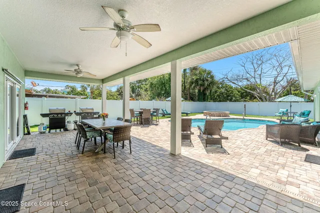 a view of a patio with a dining table and chairs