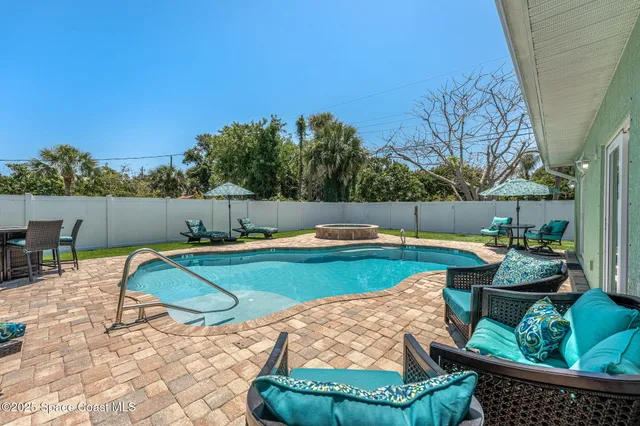 a view of swimming pool with seating space and barbeque oven