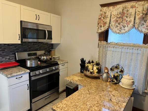 a kitchen with a stove and a microwave