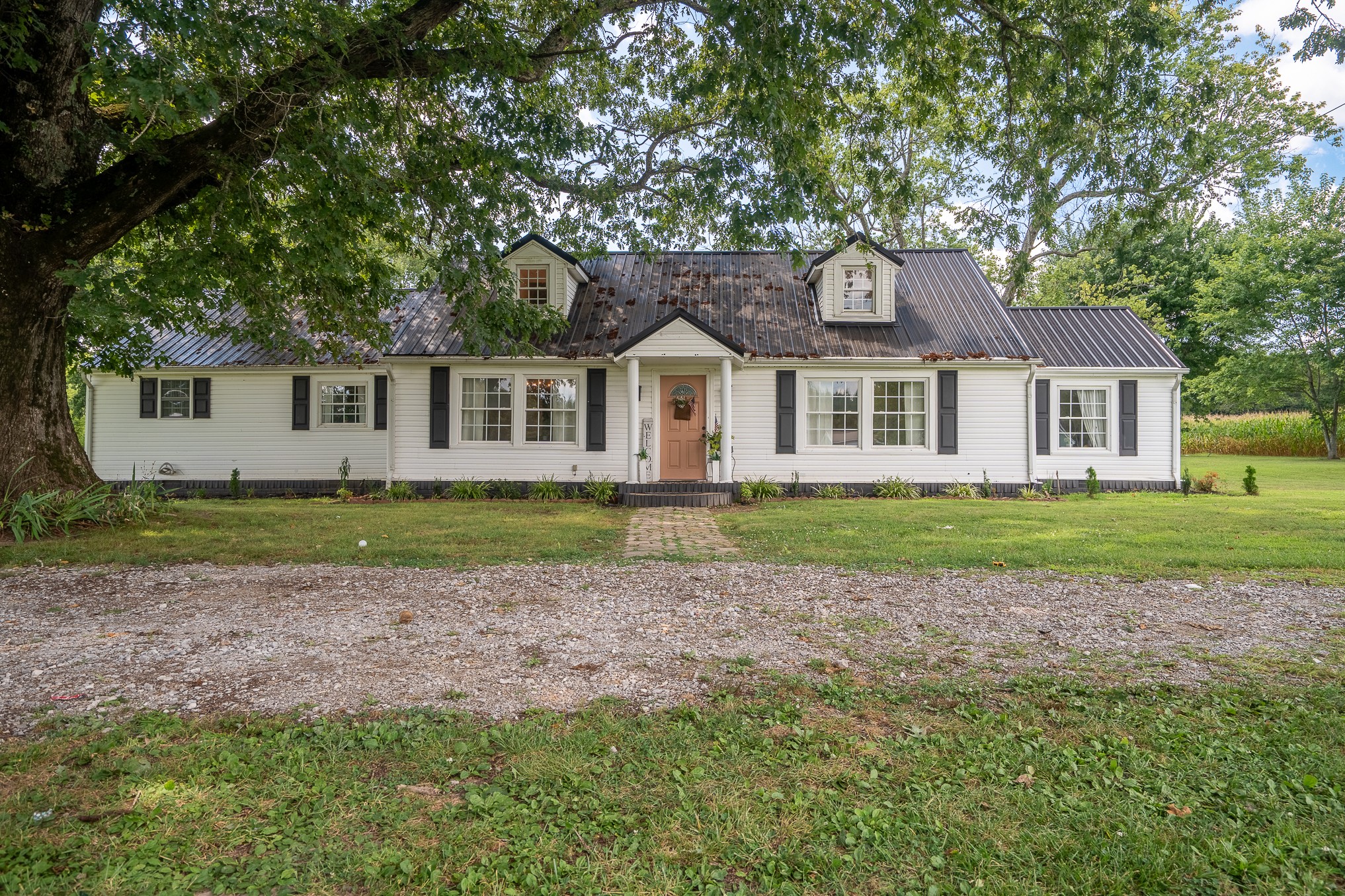 a front view of a house with a garden