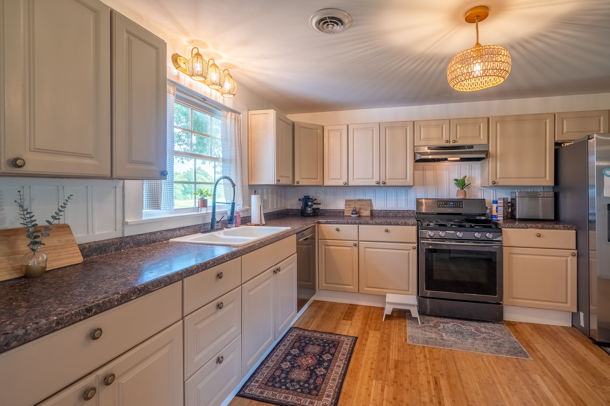 231 Rabbit Trail Road Leoma, TN 38468 - Photo 20 of 37 a kitchen with granite countertop a stove a sink dishwasher and a refrigerator