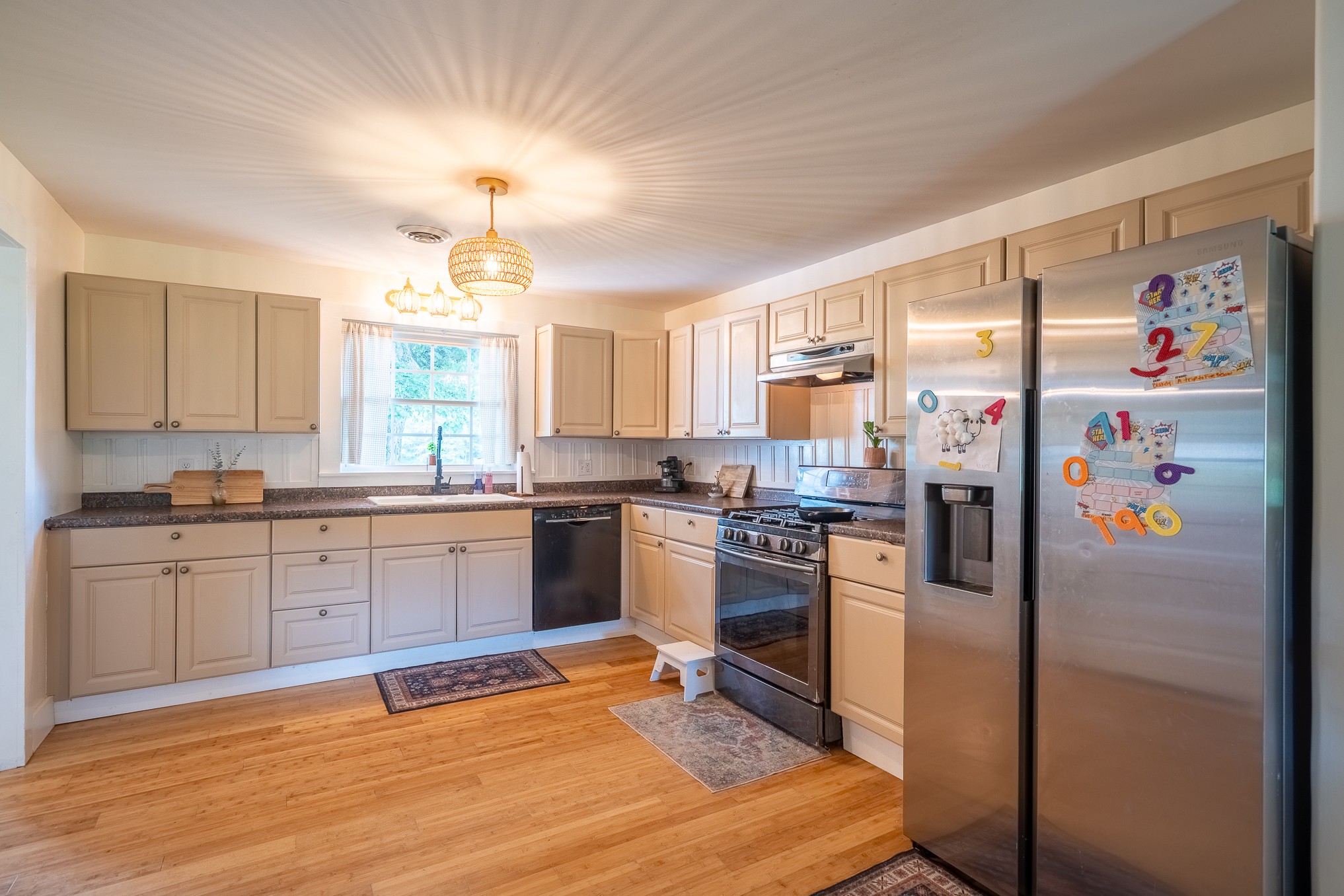 231 Rabbit Trail Road Leoma, TN 38468 - Photo 21 of 37 a kitchen with granite countertop stainless steel appliances a refrigerator cabinets and wooden floor