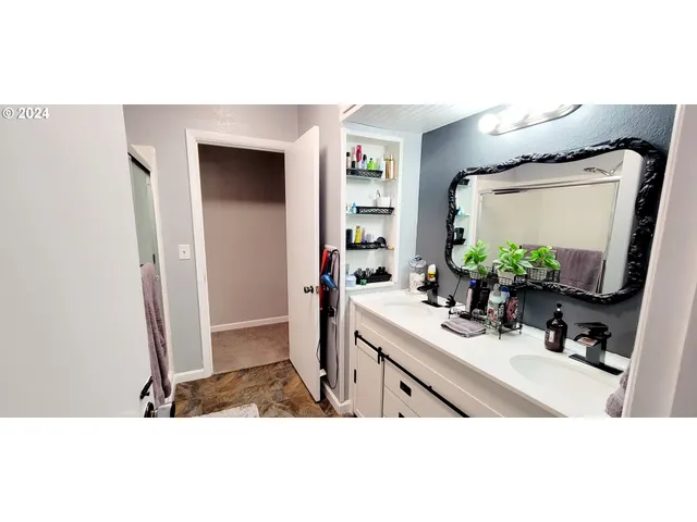 a bathroom with a sink a mirror and vanity