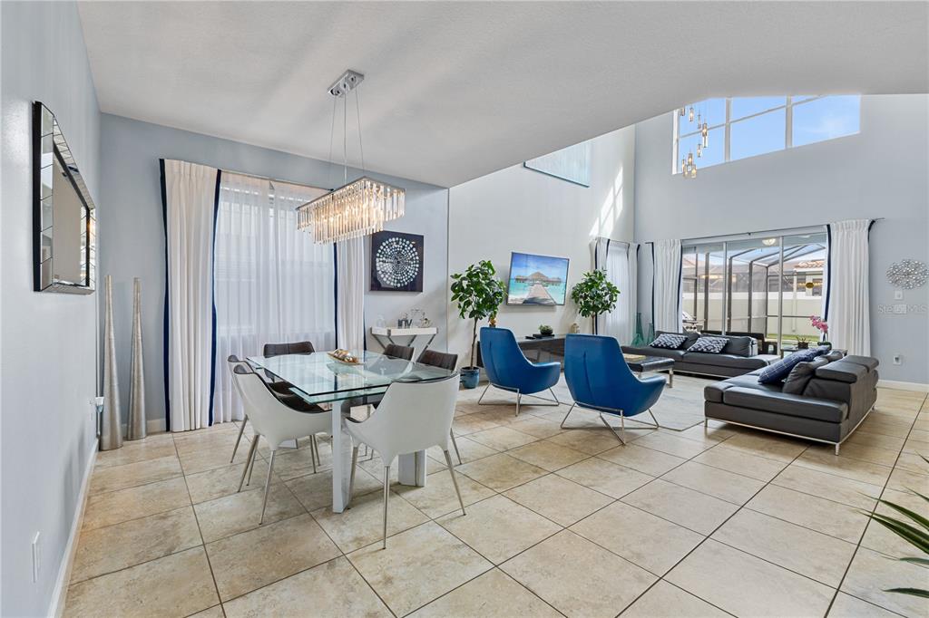 9006 Majesty Palm Road Kissimmee, FL 34747 - Photo 11 of 56 a living room with furniture a large window and a table