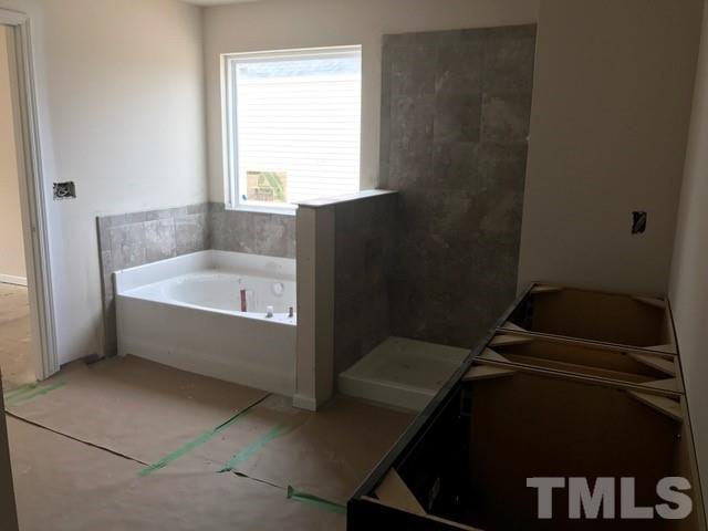 Luxury master bathroom with garden tub, separate tiled shower, tile floors, double raised vanity, and plenty of space!