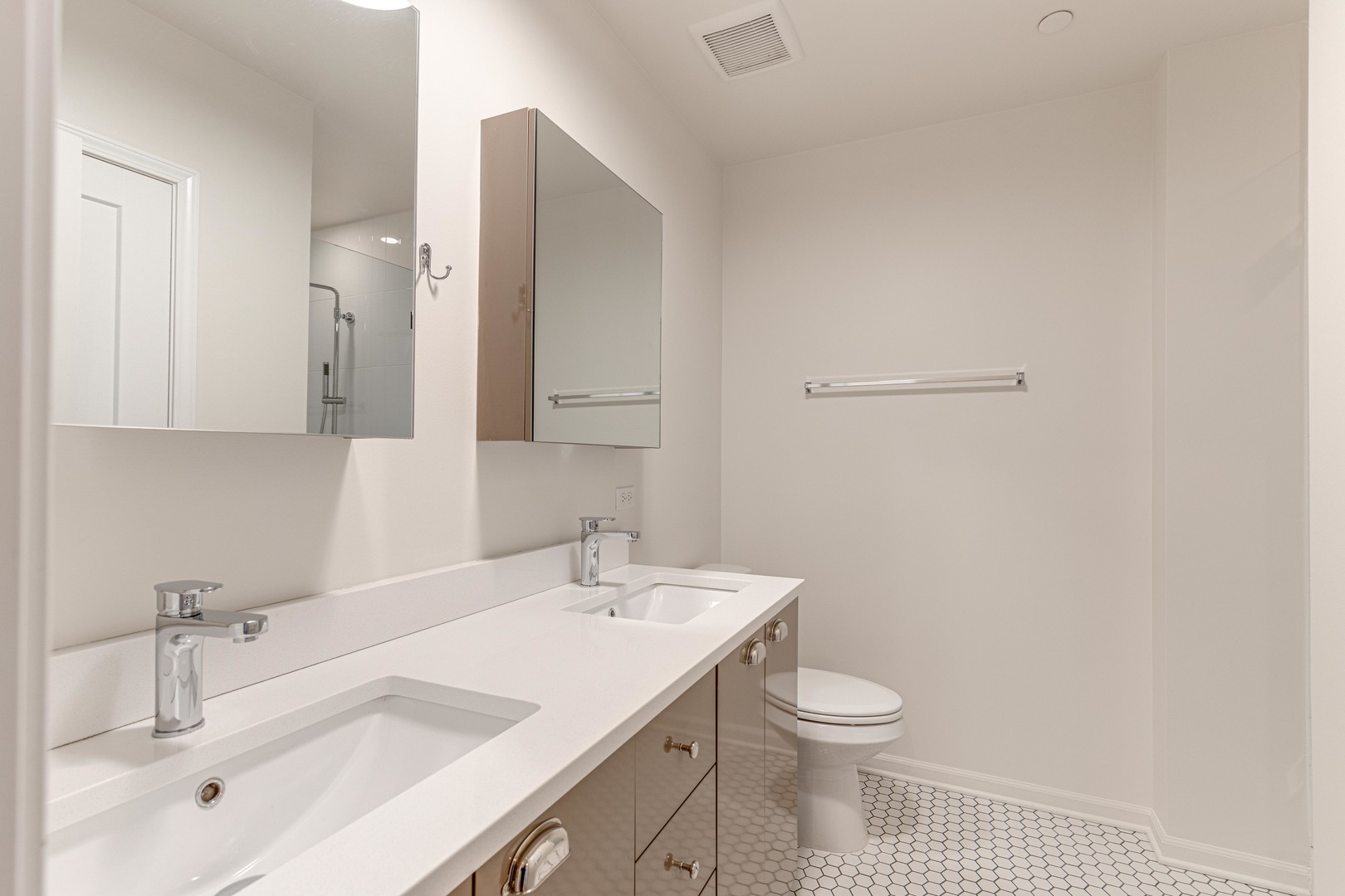 115 Lake Street, Unit 313 Libertyville, IL 60048 - Photo 9 of 10 a bathroom with a toilet a sink a mirror and vanity
