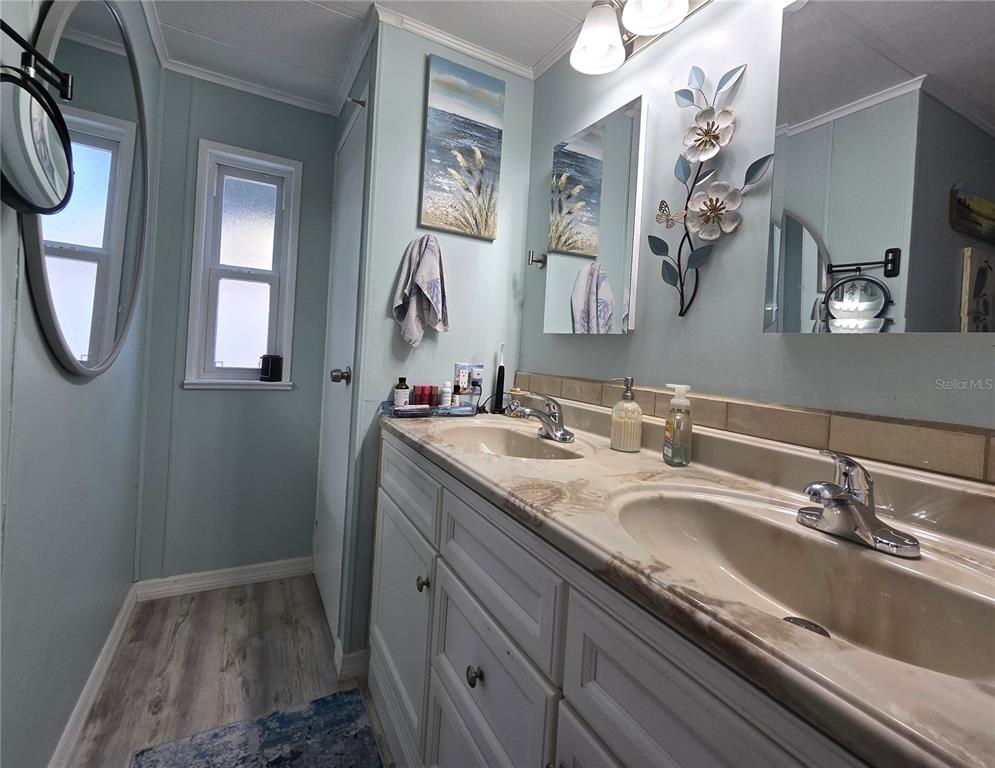 5619 Bayshore Road, Unit 435 Palmetto, FL 34221 - Photo 31 of 56 a bathroom with a granite countertop sink and a mirror