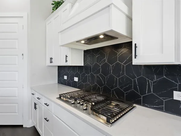 a stove top oven sitting inside of a kitchen