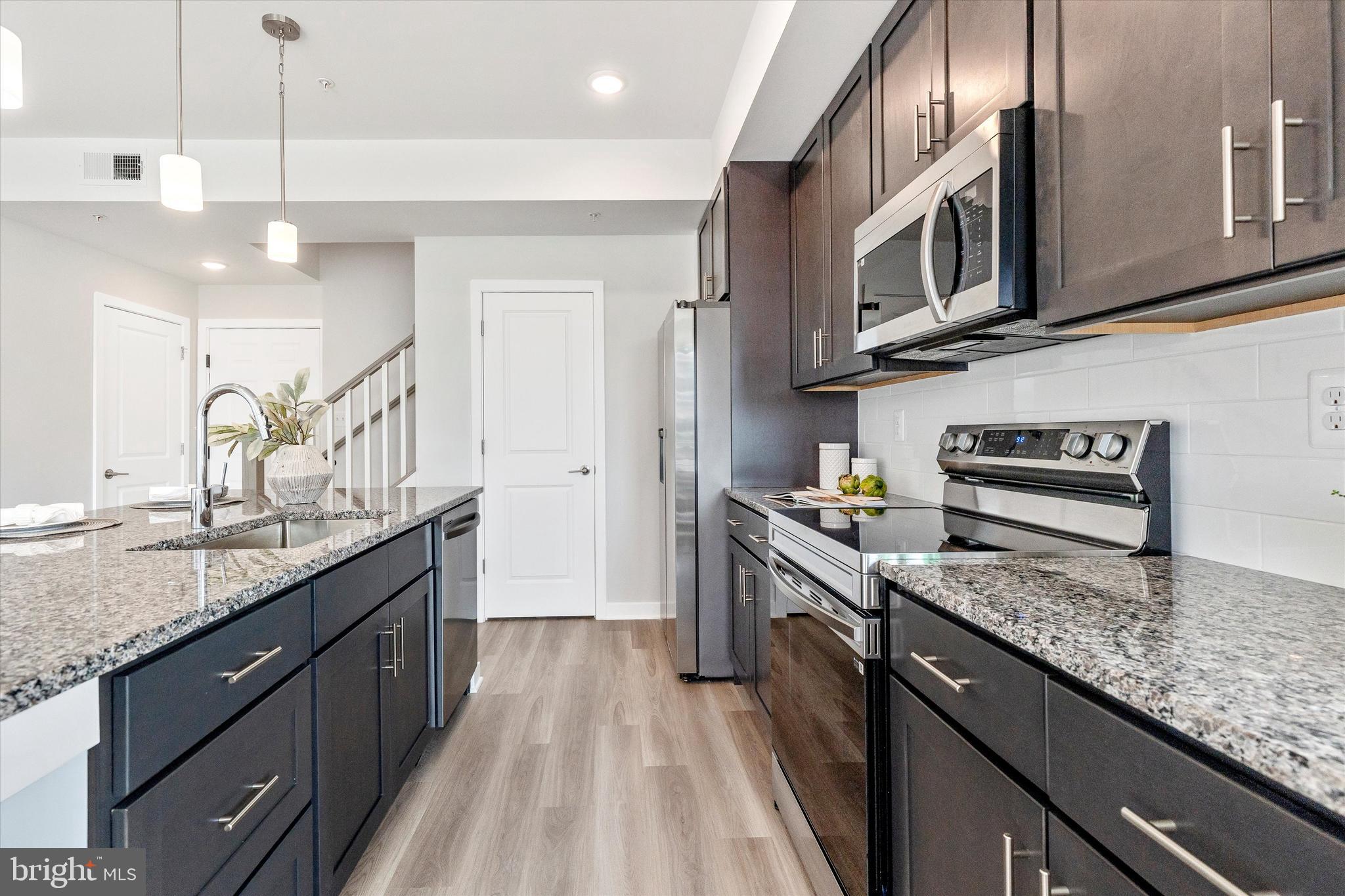 714 Iron Frg Road Frederick, MD 21702 - Photo 13 of 36 a kitchen with stainless steel appliances granite countertop a sink stove and refrigerator