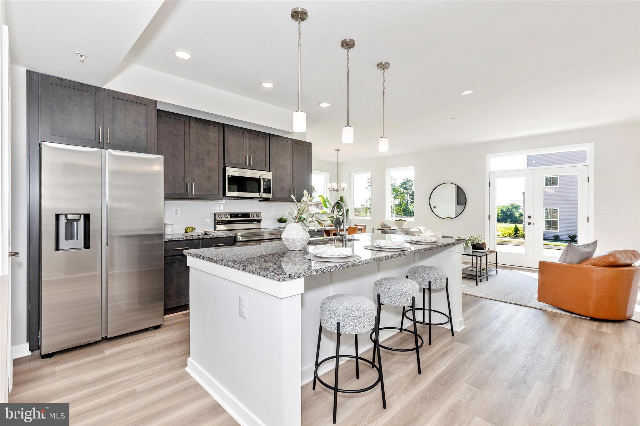 714 Iron Frg Road Frederick, MD 21702 - Photo 16 of 36 a kitchen with stainless steel appliances kitchen island a large island in the center