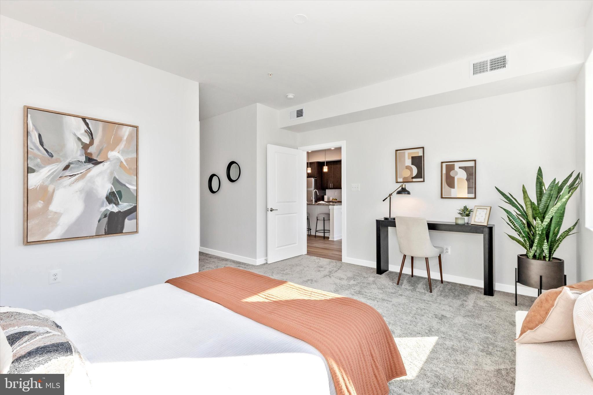 714 Iron Frg Road Frederick, MD 21702 - Photo 20 of 36 a bedroom with a large bed and paintings on the wall