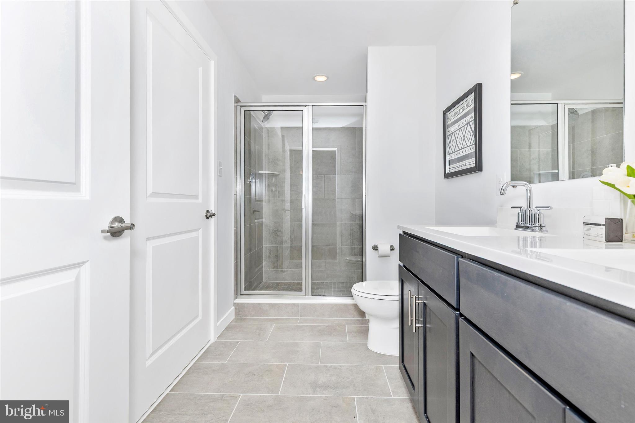 714 Iron Frg Road Frederick, MD 21702 - Photo 24 of 36 a bathroom with a sink a toilet a mirror and shower