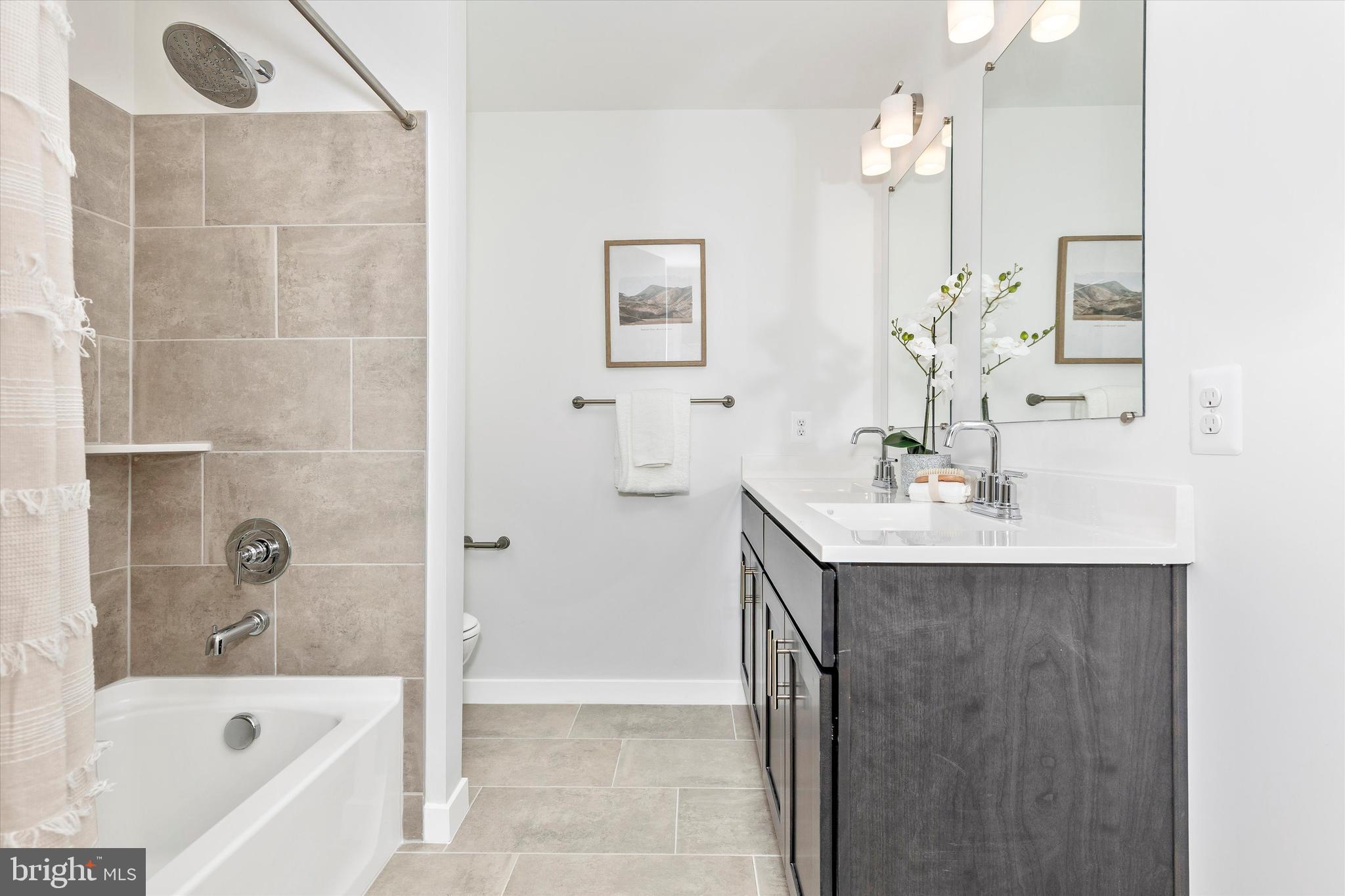 714 Iron Frg Road Frederick, MD 21702 - Photo 29 of 36 a bathroom with a bath tub a sink and mirror